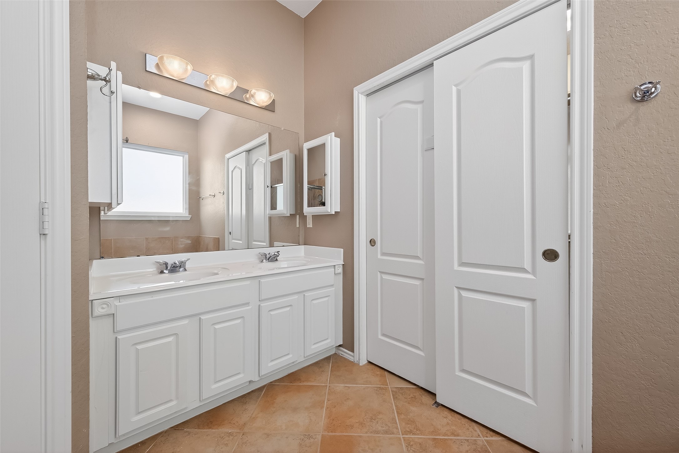 2311 Cory Crossing Lane Spring, TX 77386 - Photo 31 of 48 a spacious bathroom with a double vanity sink a mirror and a shower