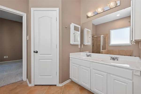 a bathroom with a double vanity sink and mirror