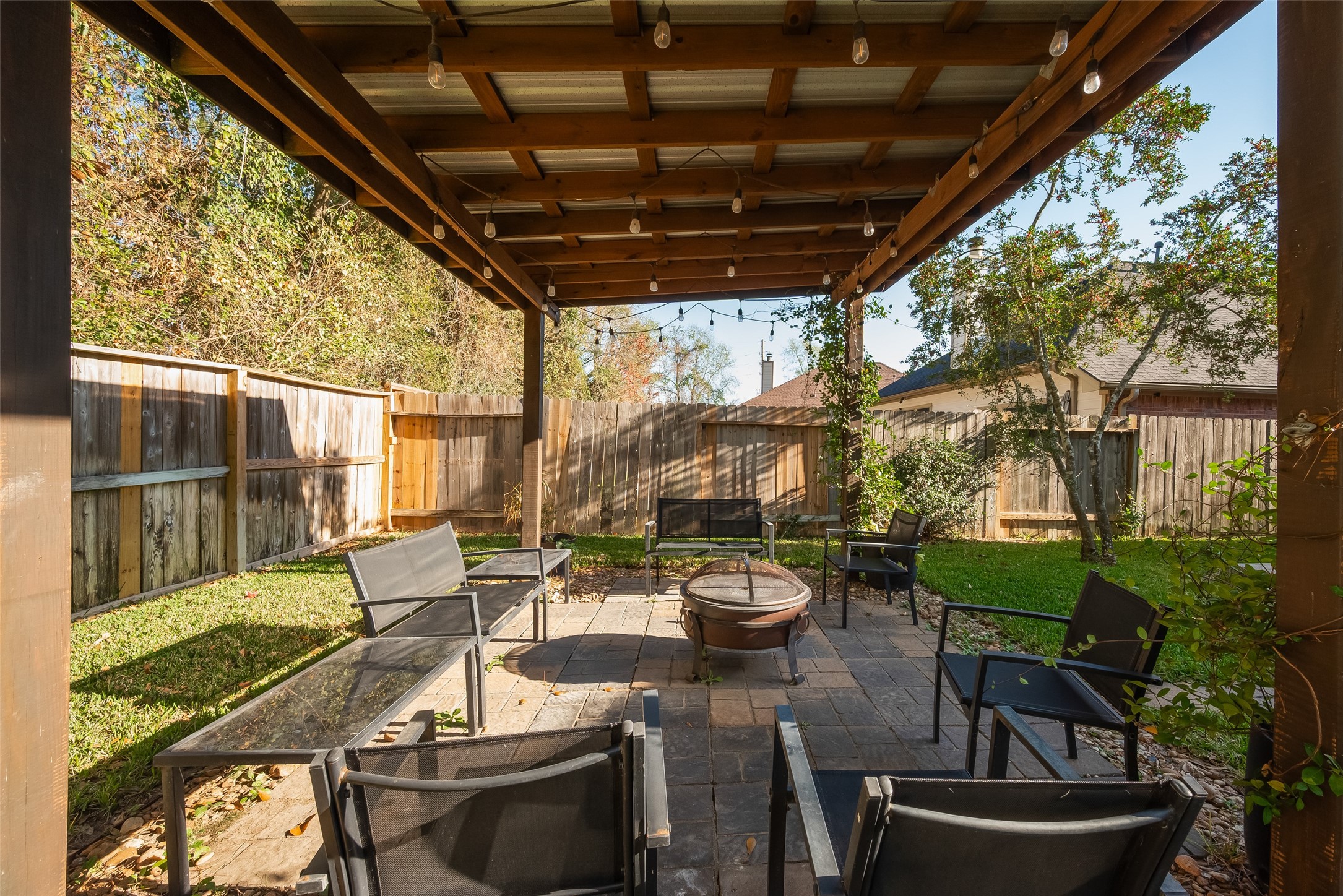 2311 Cory Crossing Lane Spring, TX 77386 - Photo 45 of 48 a view of a patio with table and chairs potted plants and floor to ceiling window