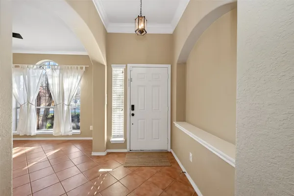 a view of a spacious bathroom with a tub shower and sink
