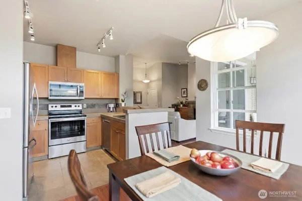 a kitchen with a table chairs stove and microwave