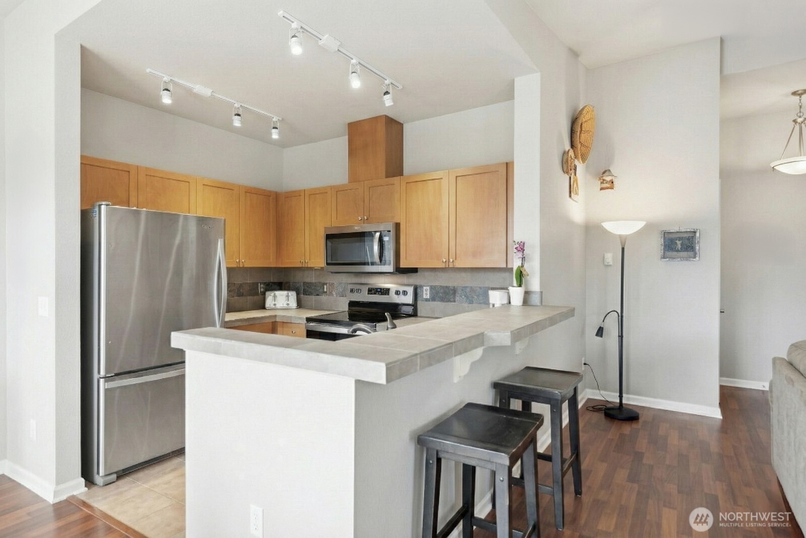 23420 Southeast Black Nugget Road, Unit F302 Issaquah, WA 98029 - Photo 10 of 19 a kitchen with stainless steel appliances a refrigerator sink and microwave