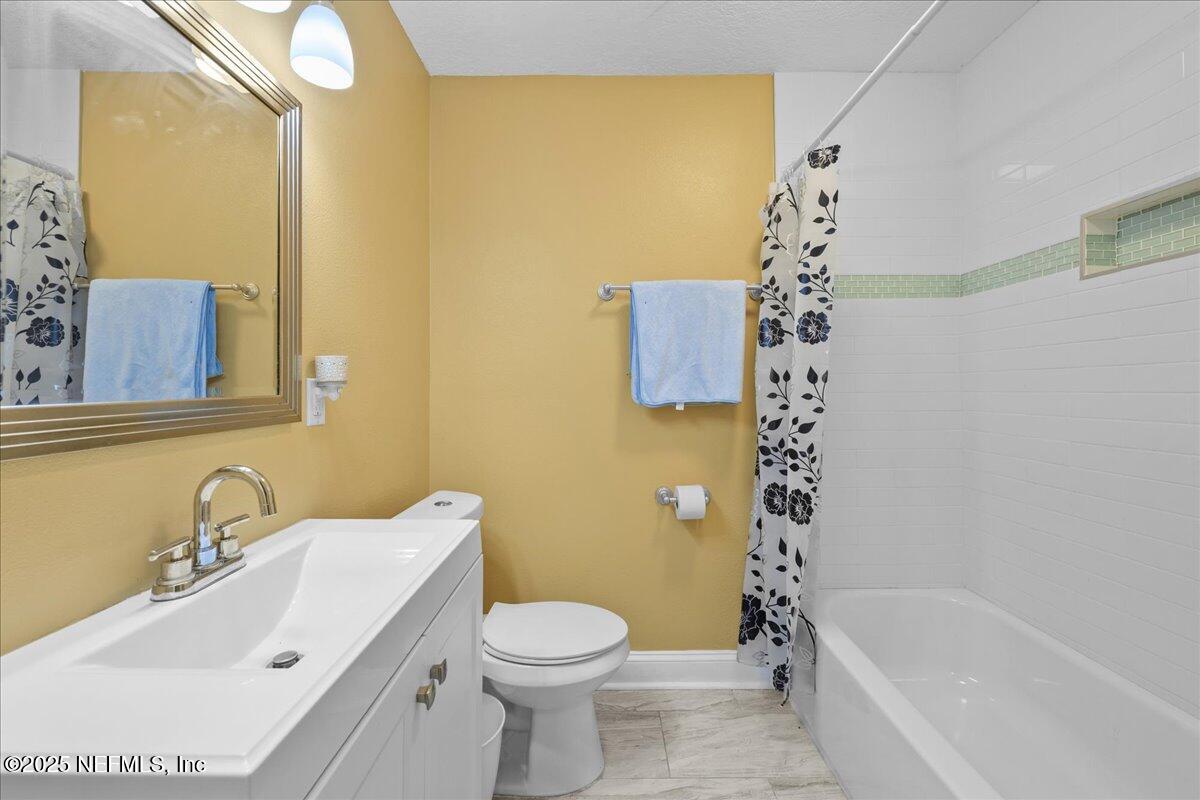 2262 Bayview Road Jacksonville, FL 32210 - Photo 20 of 27 a bathroom with a sink mirror toilet and bathtub