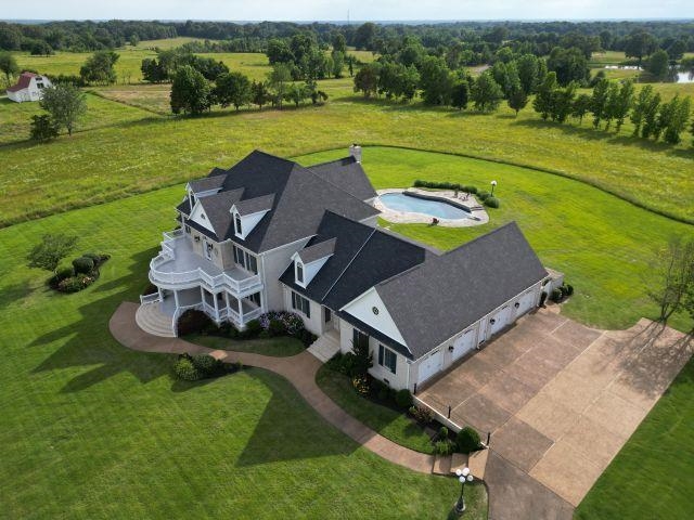 an aerial view of a house with outdoor space pool ocean view and mountain view