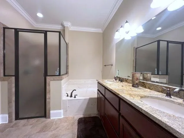 a bathroom with a tub sink and mirror