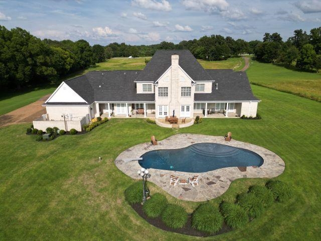 9125 Highway 196 Collierville, TN 38017 - Photo 30 of 40 a view of a white house with a swimming pool and garden