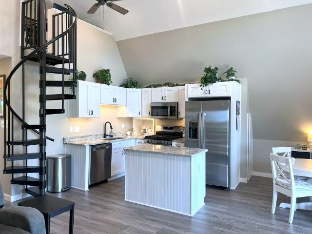 9125 Highway 196 Collierville, TN 38017 - Photo 33 of 40 a kitchen with stainless steel appliances a stove a refrigerator and wooden floor