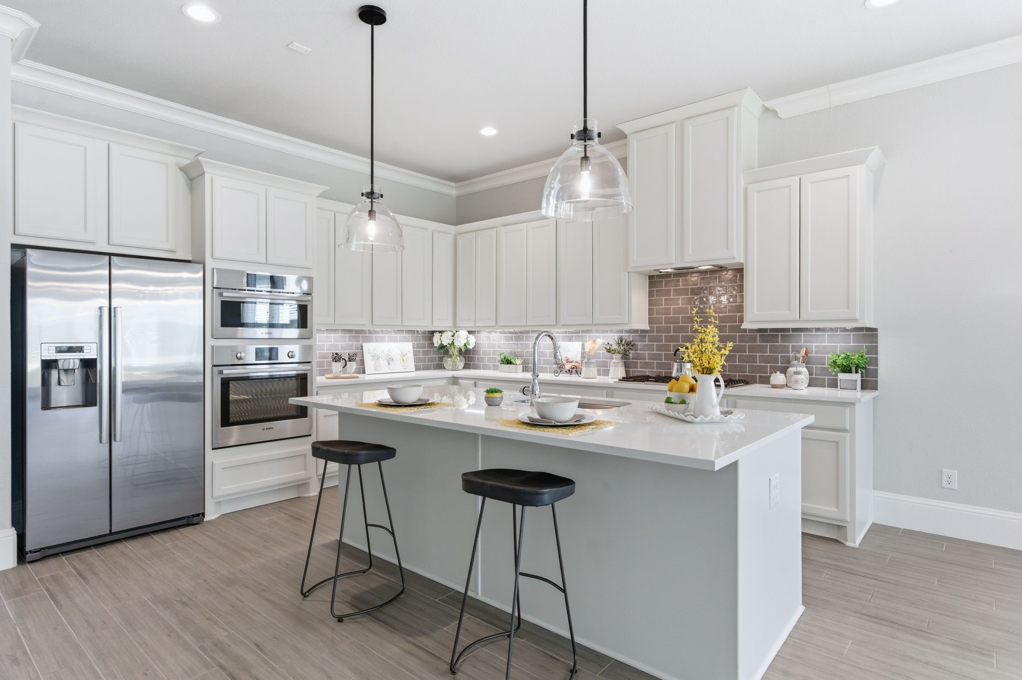 2208 Salt Grass Trail Conroe, TX 77384 - Photo 4 of 34 The Bosch appliance package in this home will delight any chef along with subtle undermount lighting, soft close cabinetry and loads of storage through this delightful kitchen space.