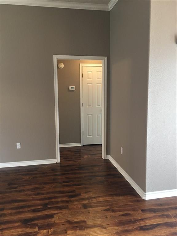 2218 Old Ironsides Road Abilene, TX 79601 - Photo 9 of 26 a view of an empty room with wooden floor and closet