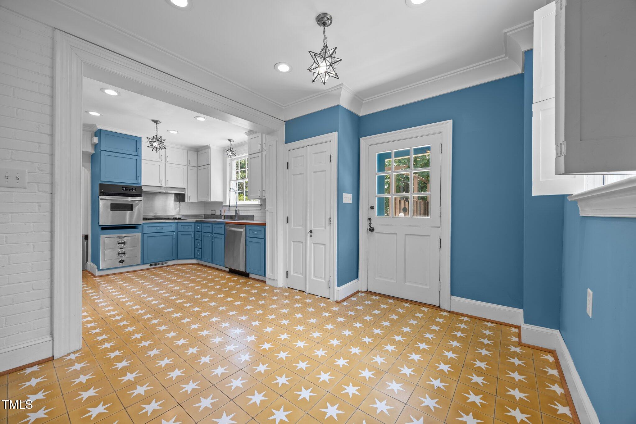 2625 Dover Road Raleigh, NC 27608 - Photo 12 of 57 a view of kitchen with granite countertop cabinets and chandelier