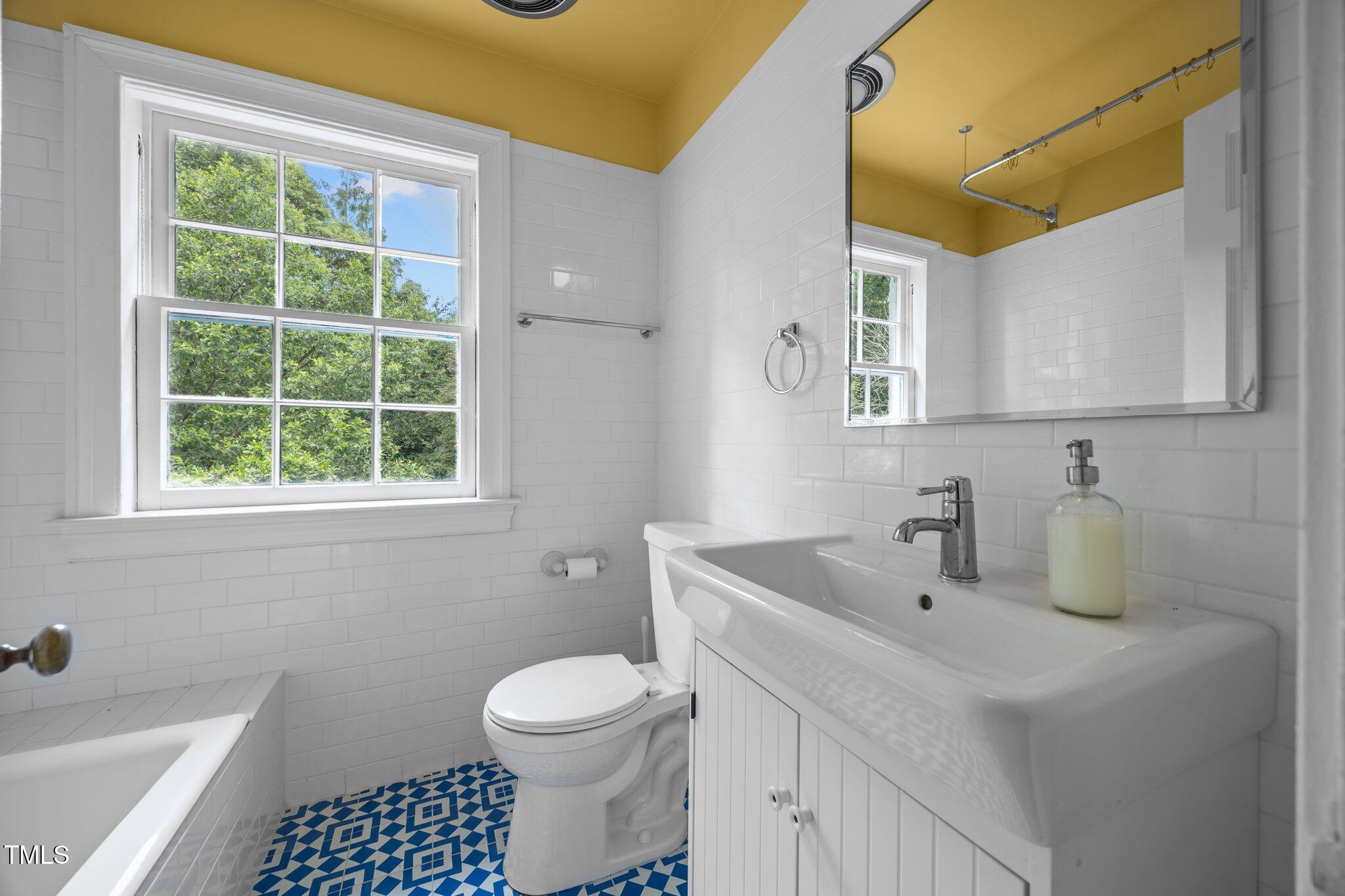 2625 Dover Road Raleigh, NC 27608 - Photo 14 of 57 a bathroom with a sink a toilet and a mirror