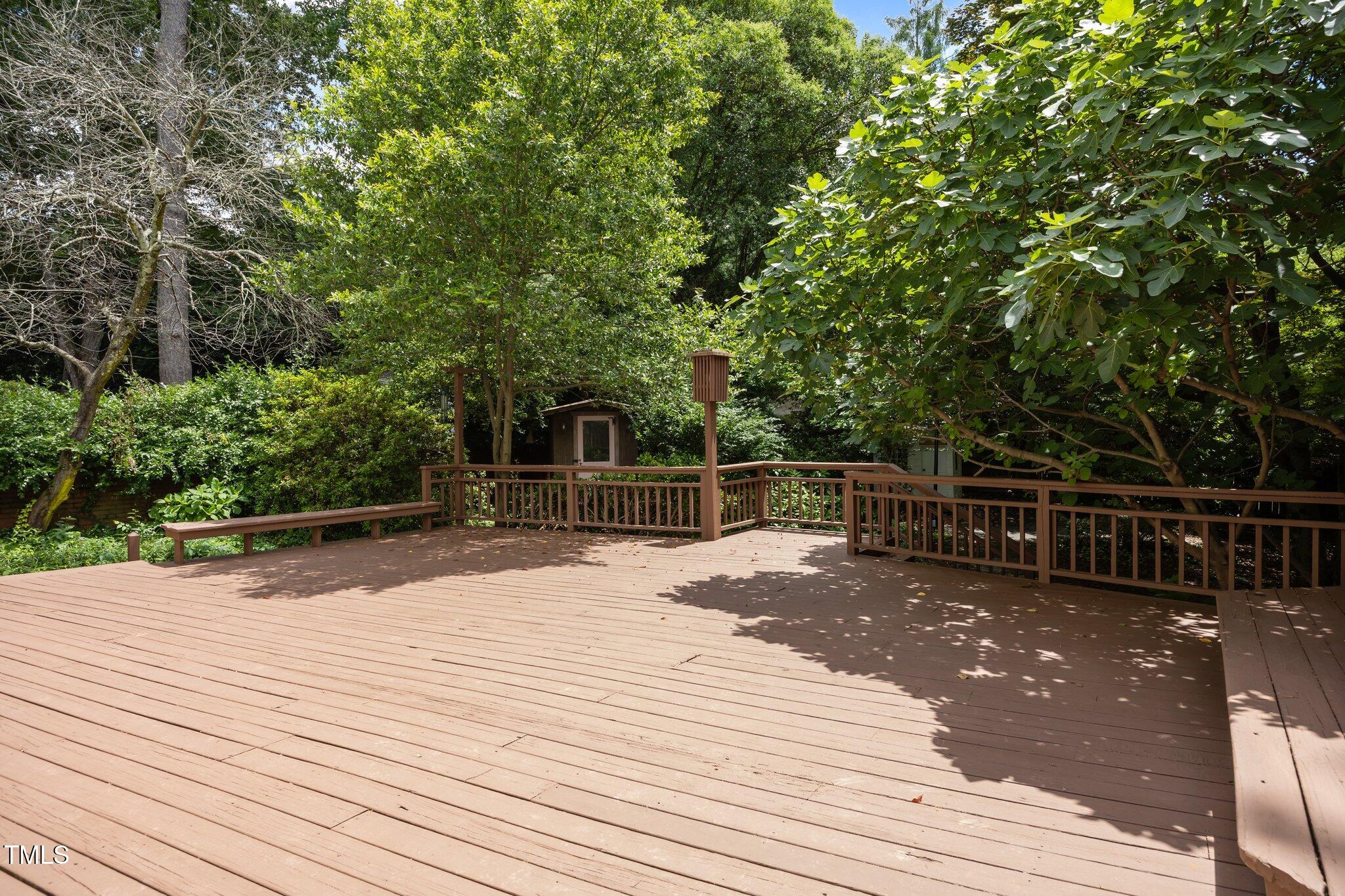 2625 Dover Road Raleigh, NC 27608 - Photo 30 of 57 a view of a wooden deck and trees with wooden fence