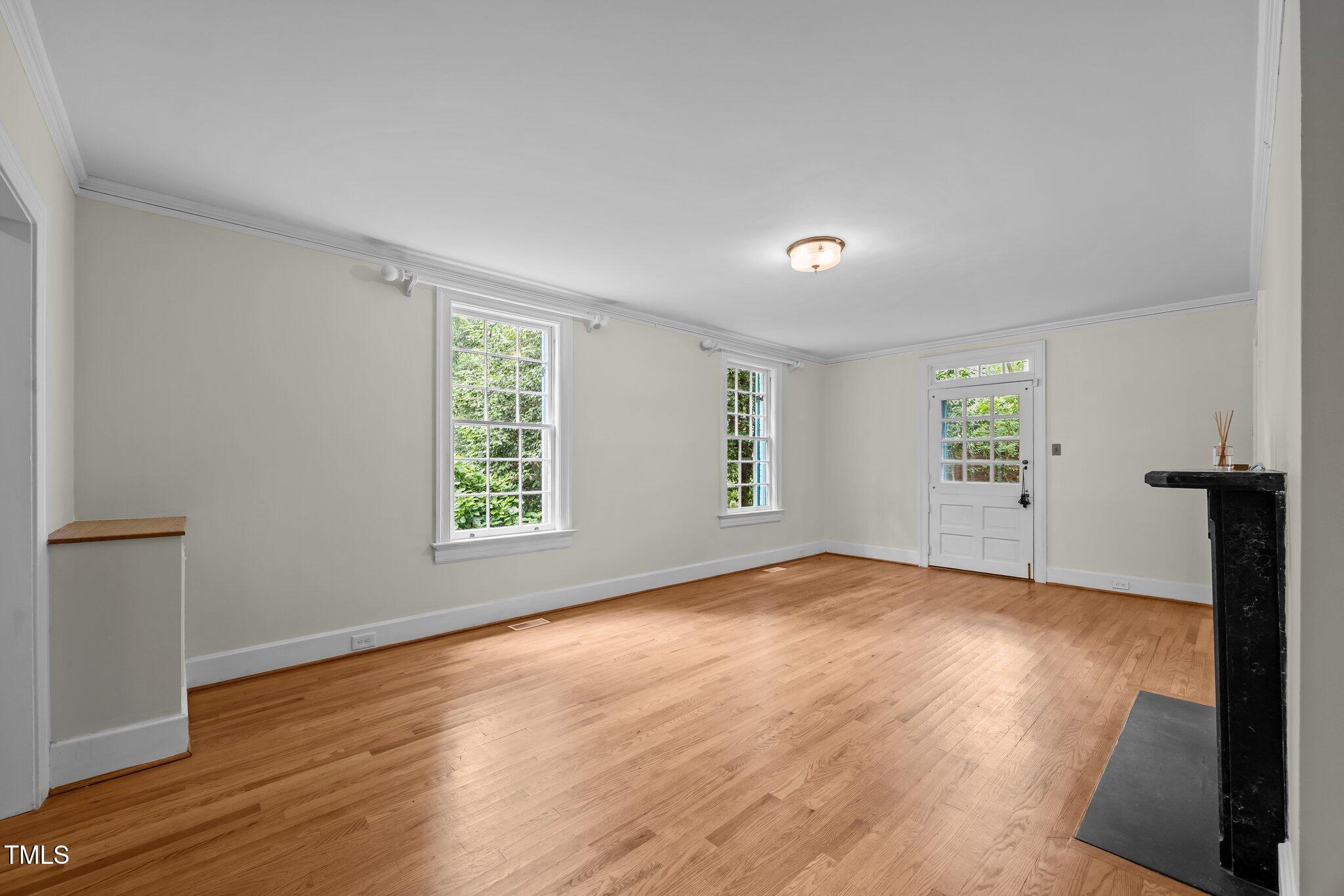 2625 Dover Road Raleigh, NC 27608 - Photo 3 of 57 wooden floor in an empty room with a window