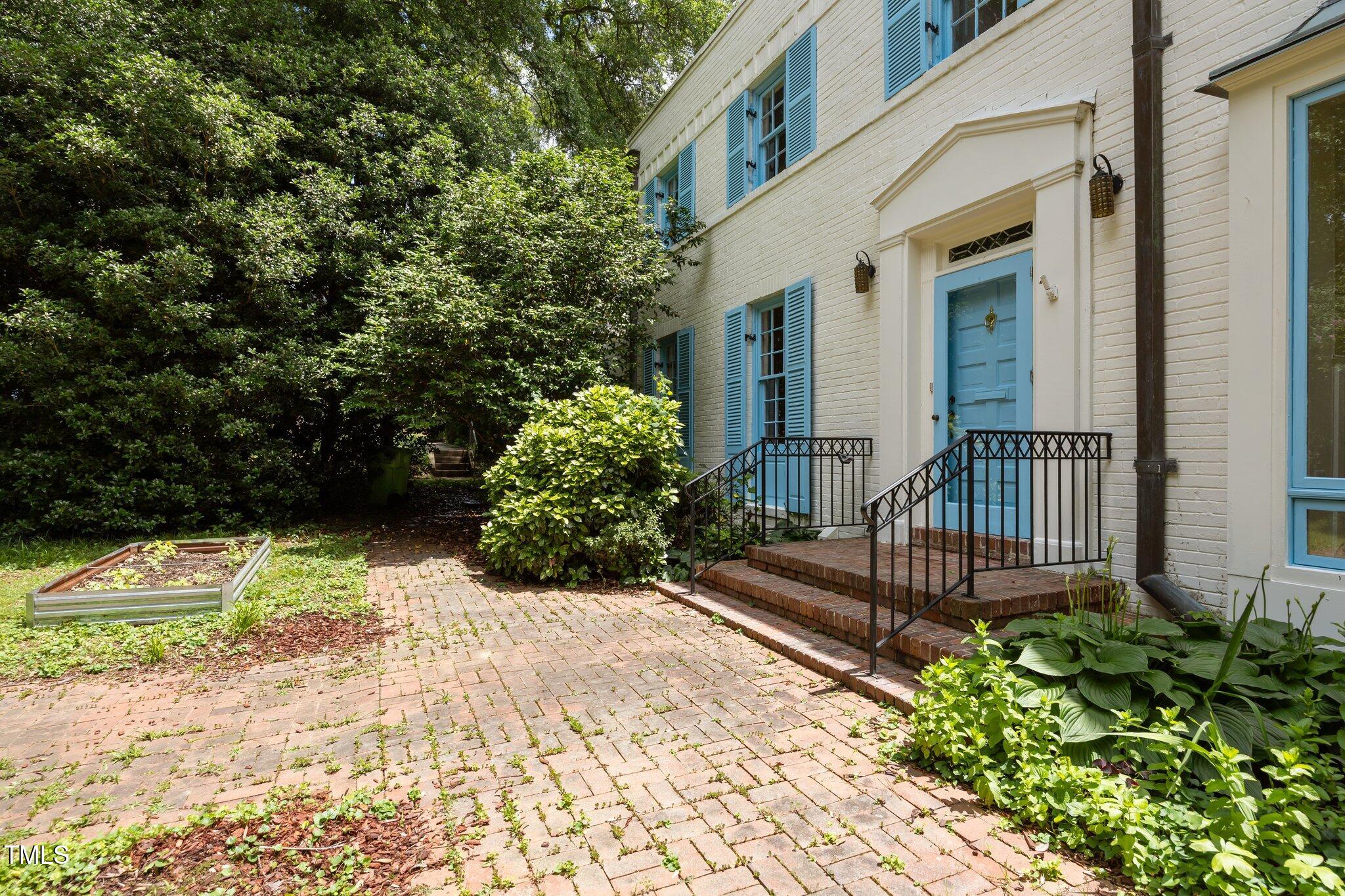 2625 Dover Road Raleigh, NC 27608 - Photo 34 of 57 a view of a house with a small yard and wooden floor and fence
