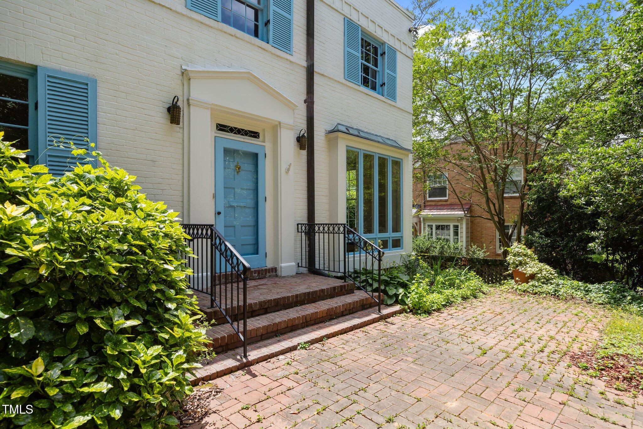 2625 Dover Road Raleigh, NC 27608 - Photo 38 of 57 a view of a house with potted plants and a tree