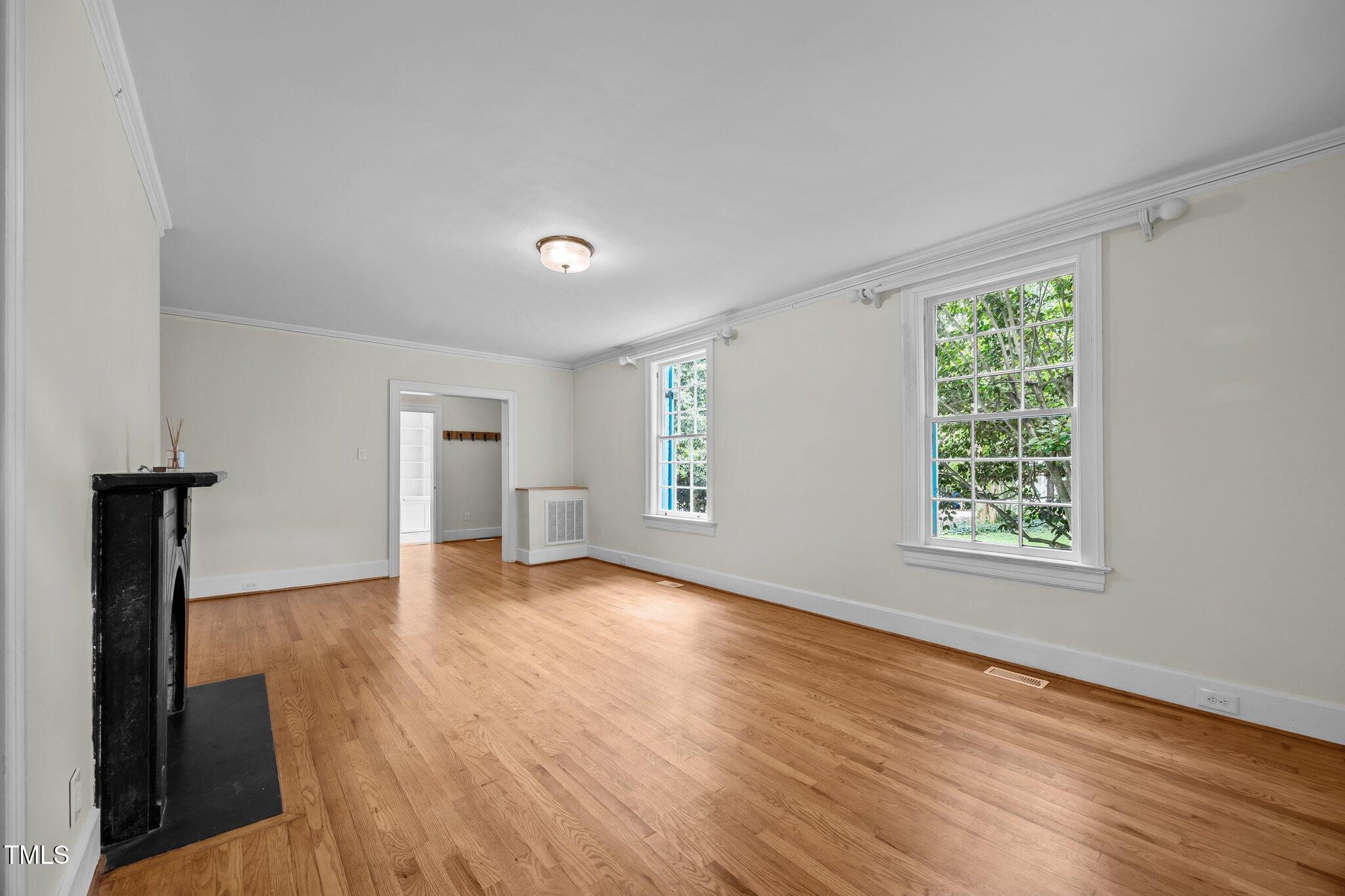 2625 Dover Road Raleigh, NC 27608 - Photo 4 of 57 a view of empty room with wooden floor and fan