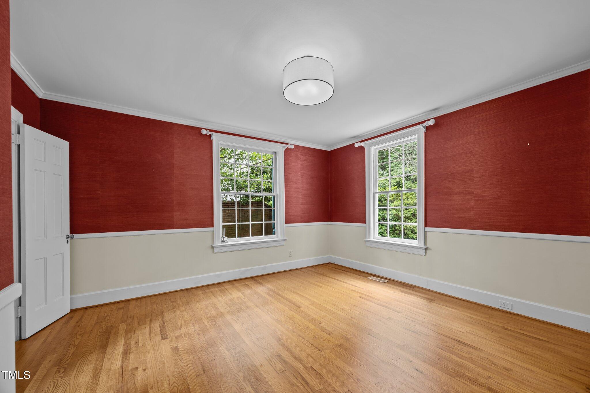 2625 Dover Road Raleigh, NC 27608 - Photo 5 of 57 an empty room with wooden floor and windows