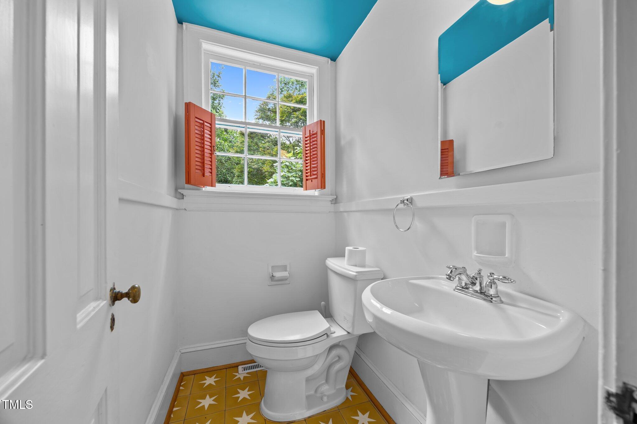 2625 Dover Road Raleigh, NC 27608 - Photo 6 of 57 a bathroom with a sink a toilet and a mirror