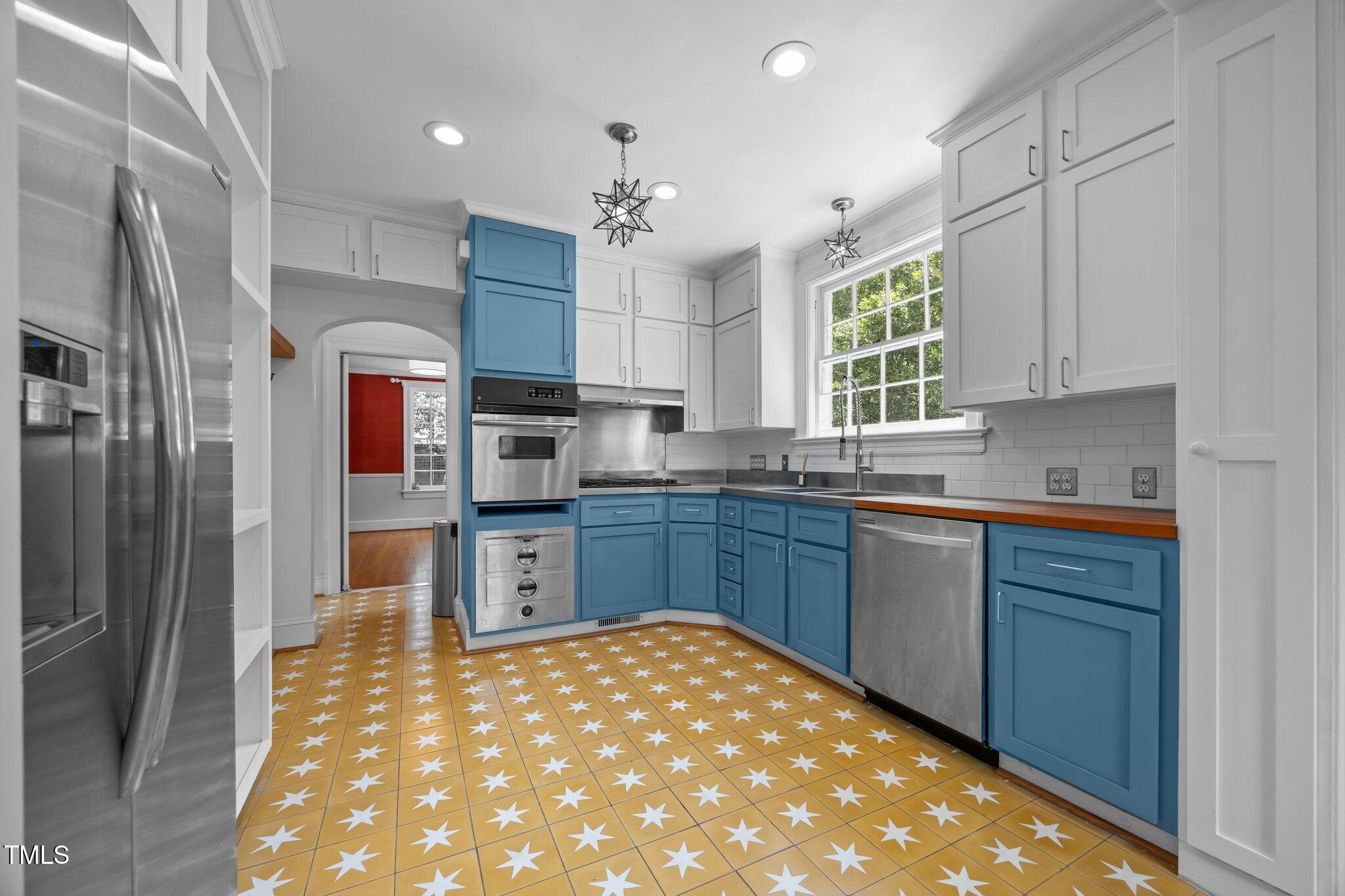 2625 Dover Road Raleigh, NC 27608 - Photo 10 of 57 a kitchen with stainless steel appliances granite countertop a refrigerator and a sink