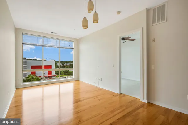 a view of a room with window and hardwood