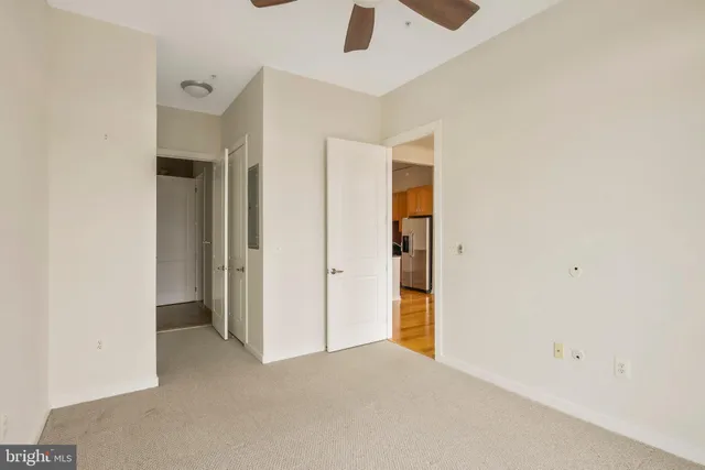 an empty room with chandelier fan