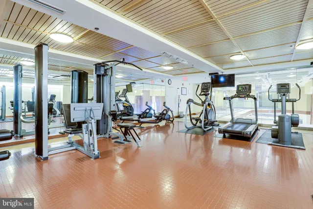 a gym room with lots of furniture