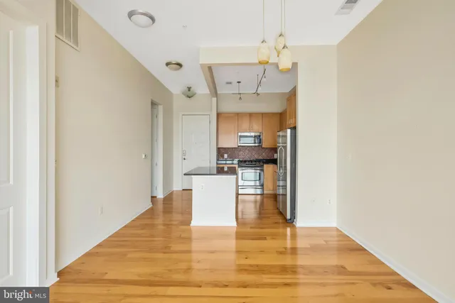 a view of kitchen and dining room with wooden floor