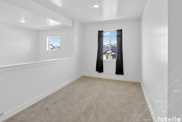 815 West Powderwood Lane Mapleton, UT 84664 - Photo 14 of 39 Unfurnished room featuring light carpet and a textured ceiling