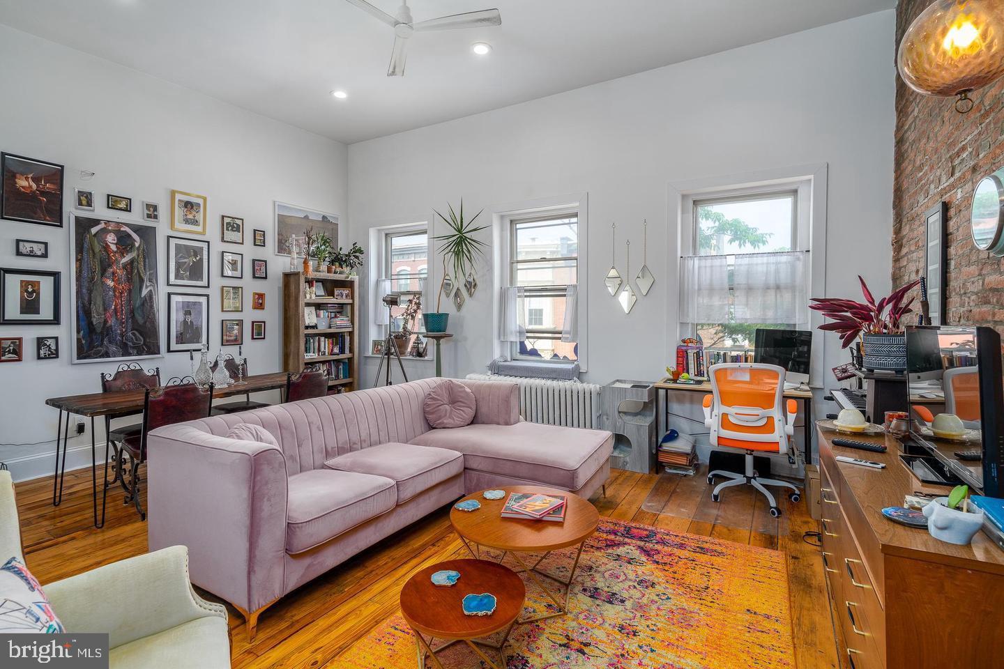 519 South 5th Street Philadelphia, PA 19147 - Photo 13 of 17 a living room with furniture a flat screen tv and a fireplace