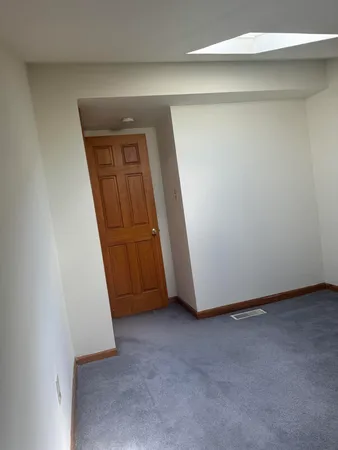 a view of a house with a wooden fence