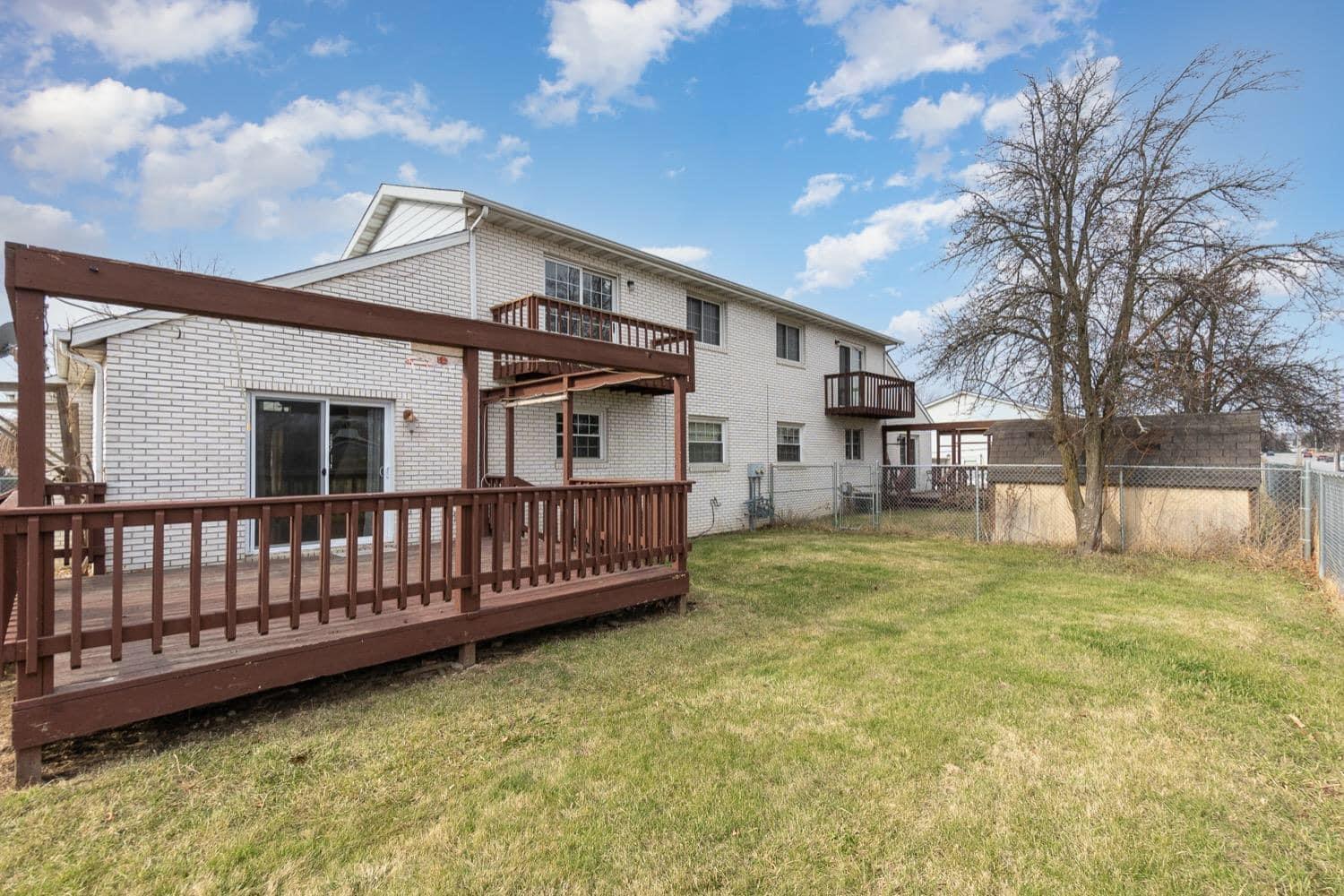 9871 Grant Place Crown Point, IN 46307 - Photo 17 of 18 a view of a house with a wooden fence