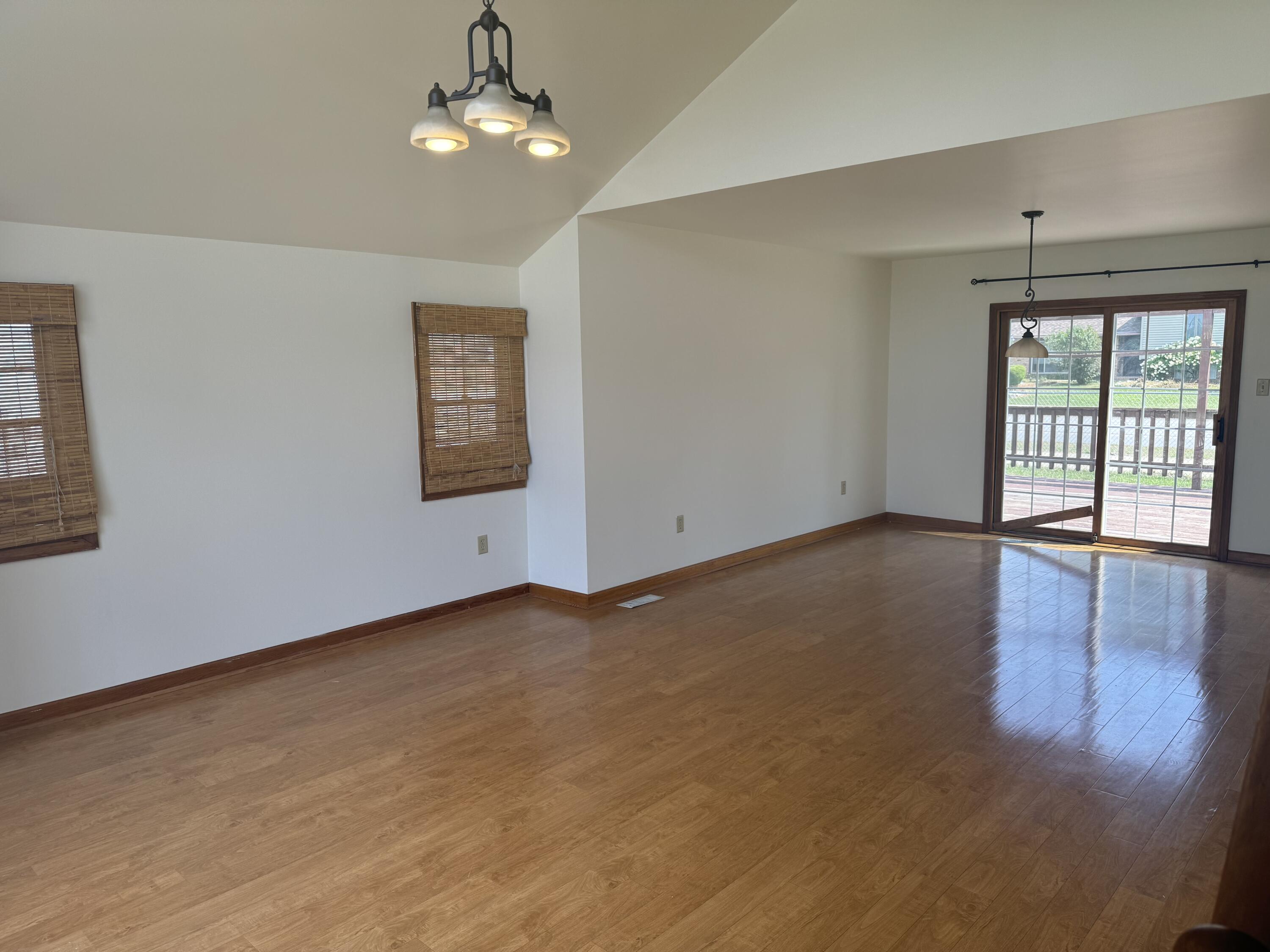 9871 Grant Place Crown Point, IN 46307 - Photo 2 of 18 wooden floor in an empty room with a window