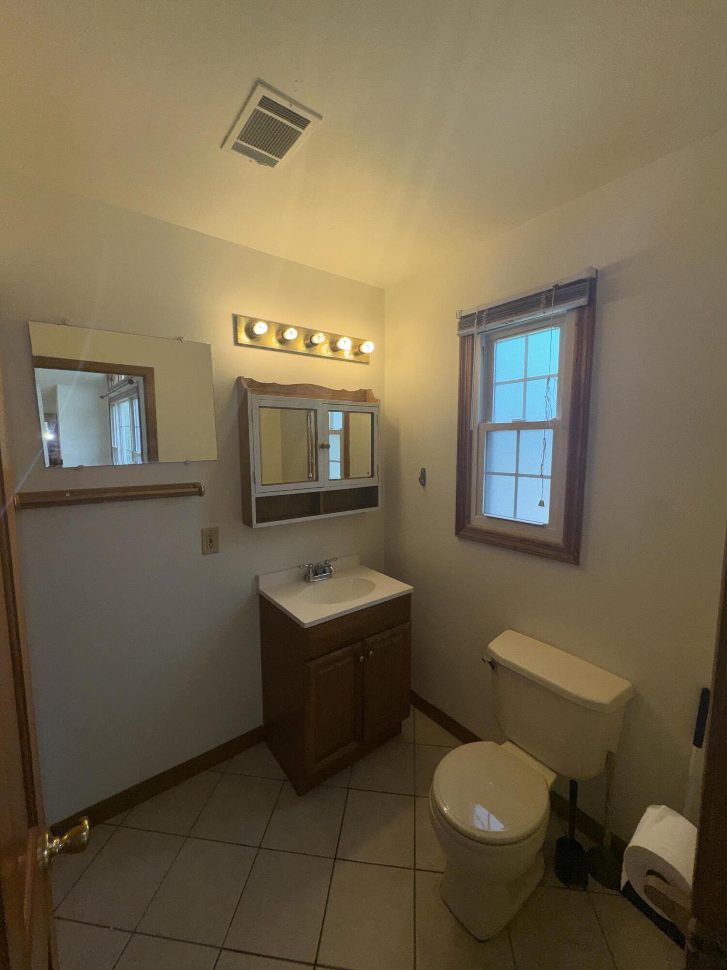9871 Grant Place Crown Point, IN 46307 - Photo 5 of 18 a bathroom with a toilet sink and mirror