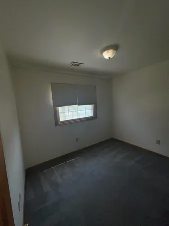 an empty room with a empty space and windows
