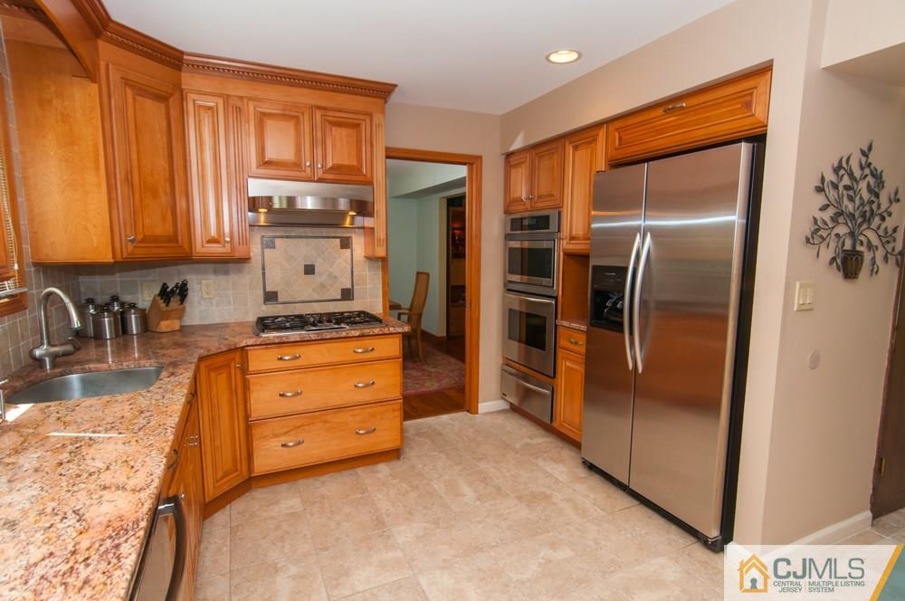 40 Higgins Road Old Bridge, NJ 08857 - Photo 11 of 46 a kitchen with stainless steel appliances granite countertop a refrigerator and a sink