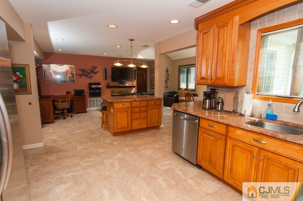 40 Higgins Road Old Bridge, NJ 08857 - Photo 12 of 46 a kitchen with stainless steel appliances a sink a counter top space cabinets and a large window