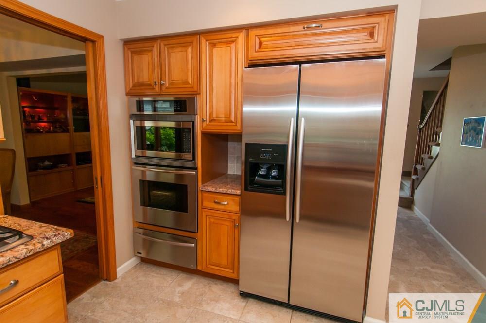 40 Higgins Road Old Bridge, NJ 08857 - Photo 13 of 46 a kitchen with stainless steel appliances granite countertop a refrigerator and a stove
