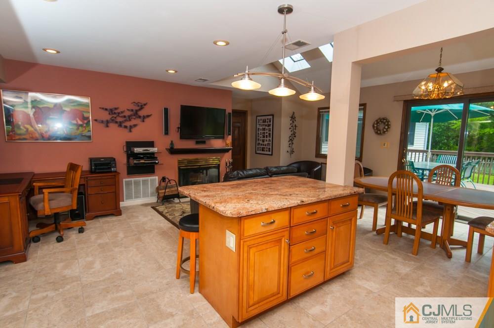 40 Higgins Road Old Bridge, NJ 08857 - Photo 14 of 46 a open kitchen with stainless steel appliances granite countertop a stove top oven a dining table and chairs