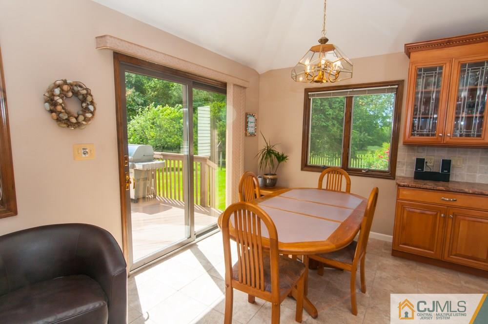 40 Higgins Road Old Bridge, NJ 08857 - Photo 16 of 46 a view of a dining room with furniture a chandelier and wooden floor