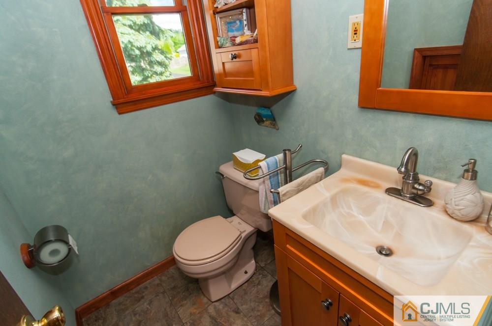 40 Higgins Road Old Bridge, NJ 08857 - Photo 18 of 46 a bathroom with a sink a toilet and mirror