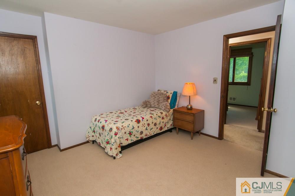 40 Higgins Road Old Bridge, NJ 08857 - Photo 29 of 46 a bedroom with a bed a couch and a window