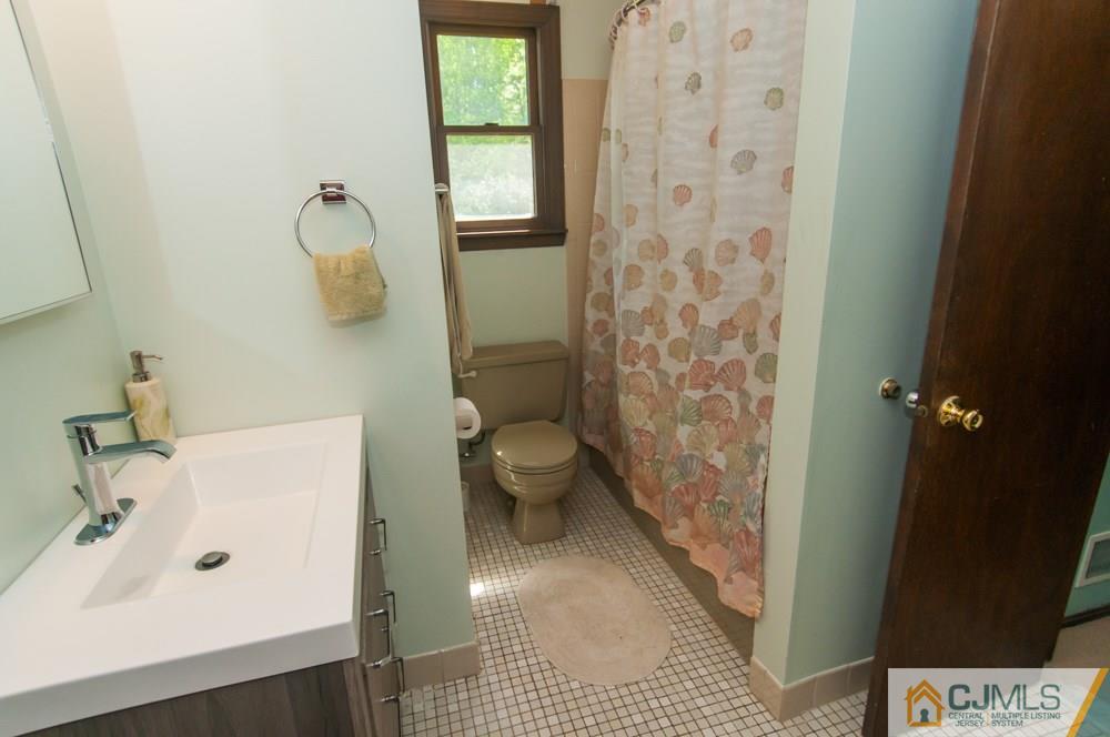 40 Higgins Road Old Bridge, NJ 08857 - Photo 33 of 46 a bathroom with a sink and a mirror