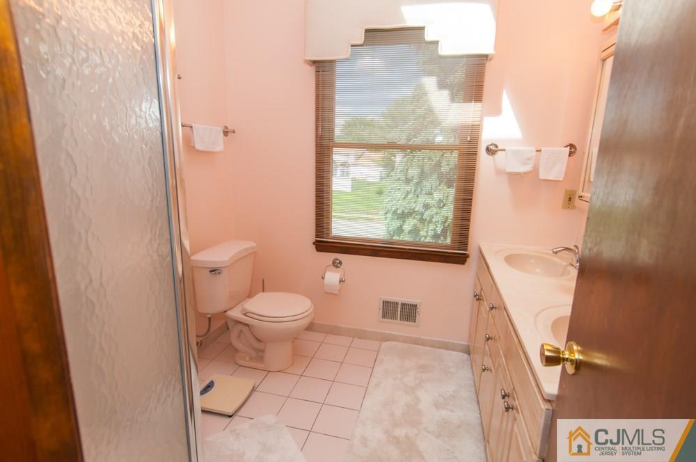 40 Higgins Road Old Bridge, NJ 08857 - Photo 40 of 46 a bathroom with a granite countertop toilet and a sink