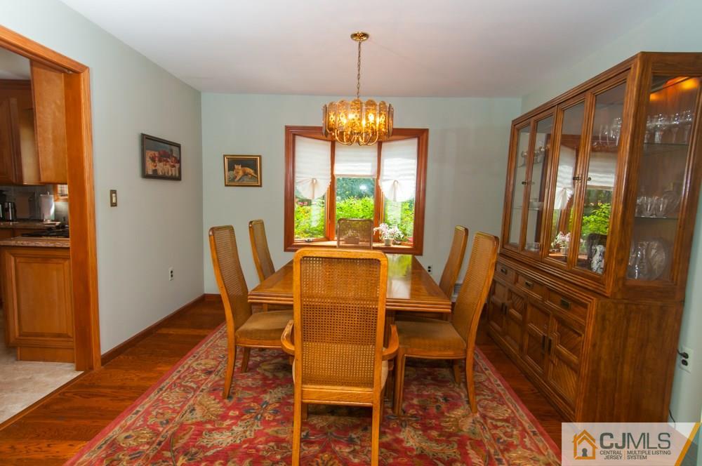 40 Higgins Road Old Bridge, NJ 08857 - Photo 8 of 46 a dining room with furniture a chandelier and wooden floor