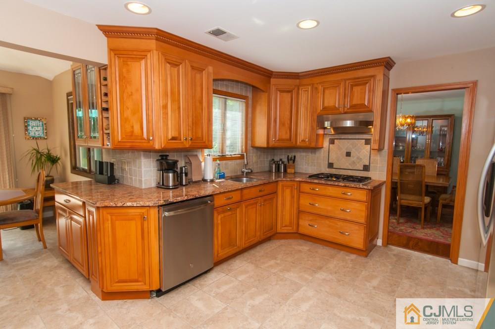 40 Higgins Road Old Bridge, NJ 08857 - Photo 10 of 46 a kitchen with stainless steel appliances granite countertop a stove a sink and a refrigerator