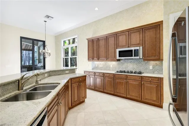 a view of a kitchen with a sink and a window