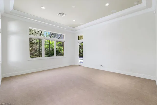 a spacious bathroom with a tub a double vanity sink and a large mirror