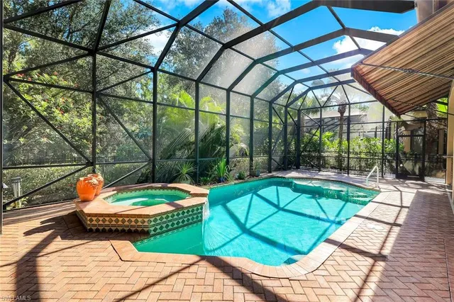 a view of swimming pool with a lounge chair and a backyard