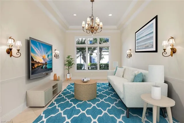 a living room with furniture and a chandelier
