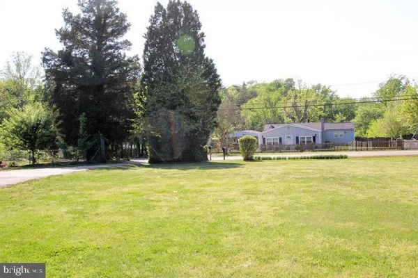 a view of a swimming pool with an outdoor seating and a yard